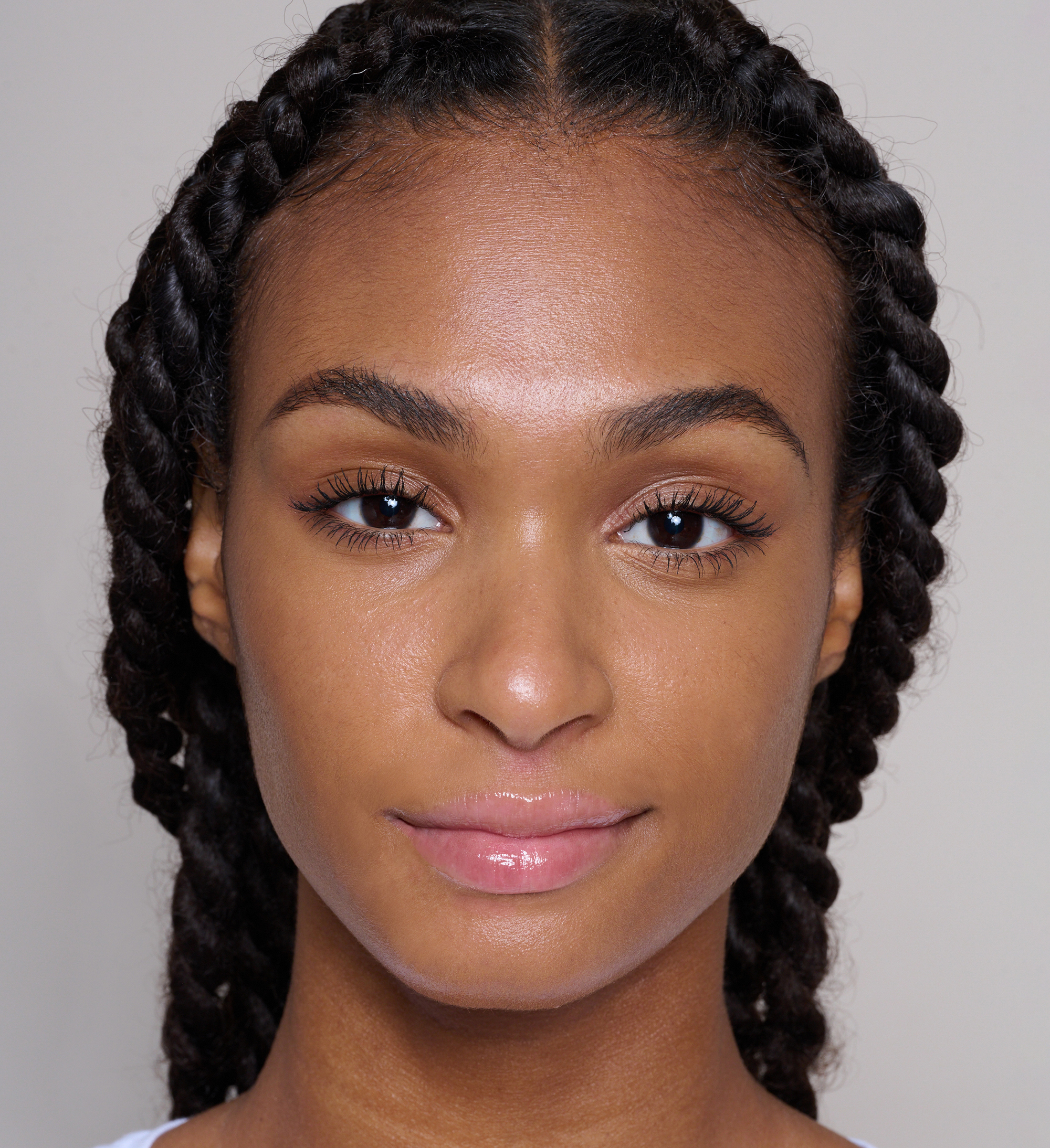 Model wearing Skin Loving BB Cream Radiantly Deep, Sculpting Brow Builder and Intensifying Lash Lover Mascara