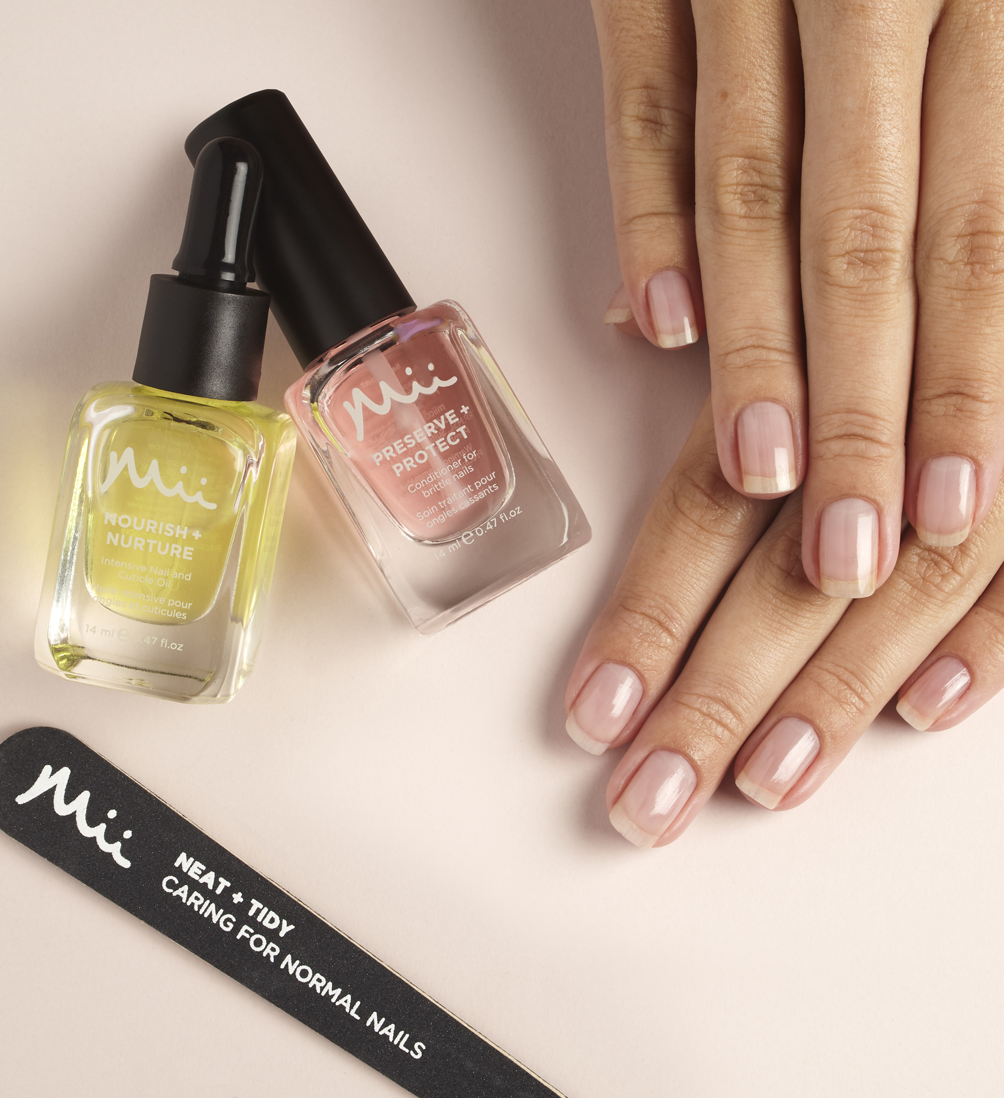 Model with natural nails, Nourish + Nurture Nail and Cuticle Oil, Preserve + Protect Base Coat and Neat + Tidy emery board