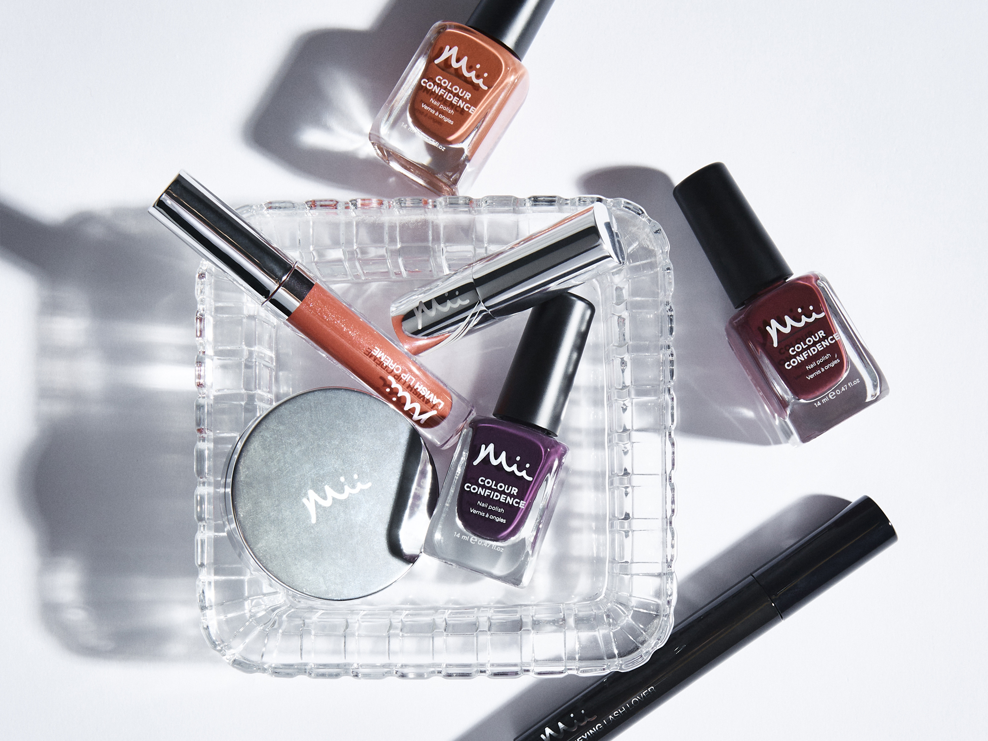 Stylised shot featuring Amplifying Lash Lover Mascara, Colour Wonder Lip and Cheek Balm, Hydraboost Lip Lover Lipstick, Colour Confidence Nail Polish and Lavish Lip Creme