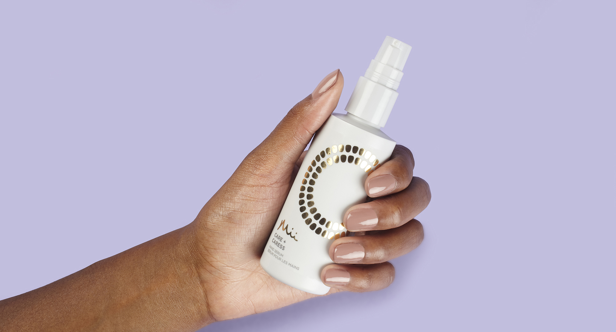 Model holding Care + Caress Hand Serum
