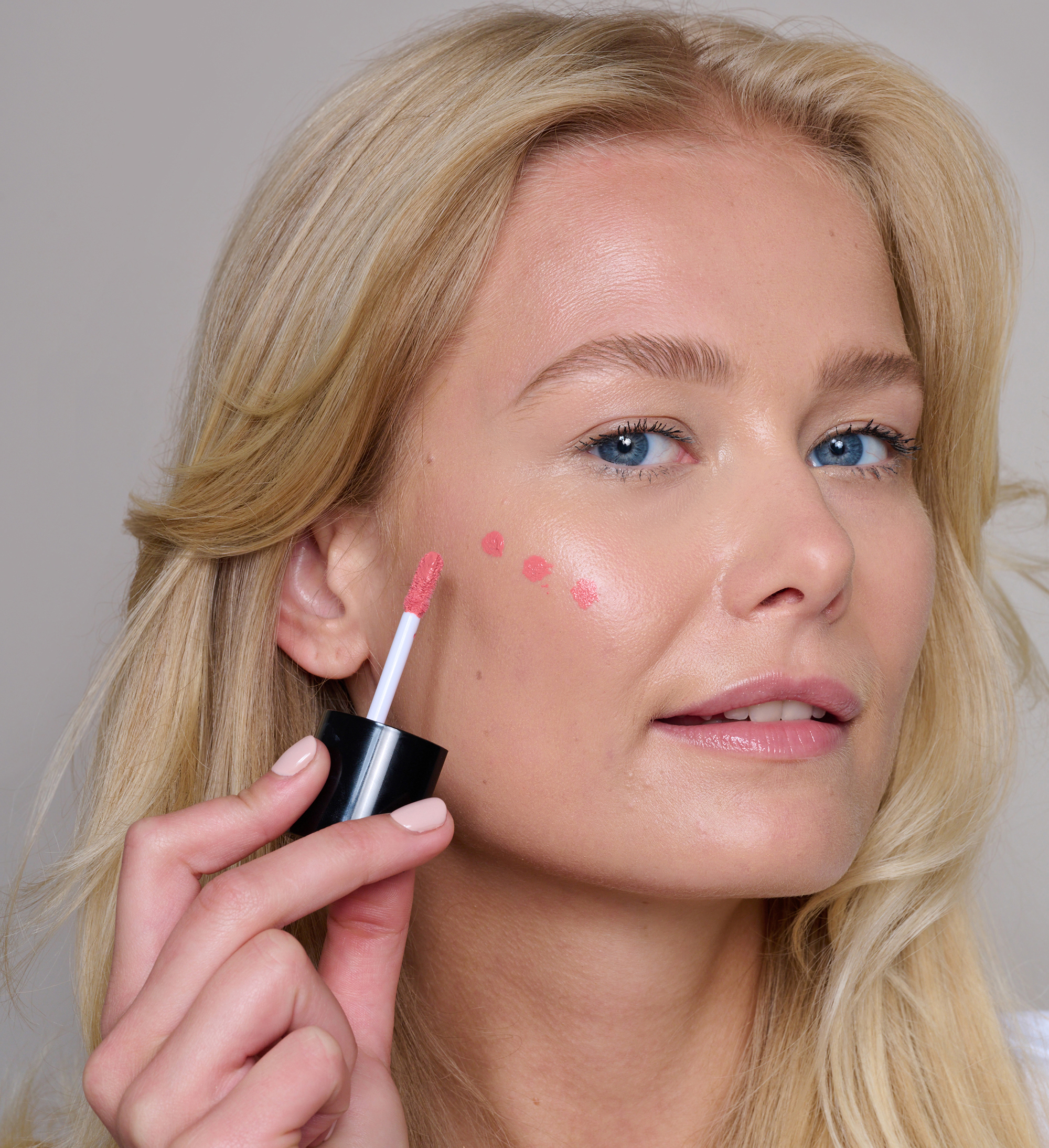 Model wearing Skin Loving BB Cream, Amplifying Lash Lover mascara, Cheek Veil Liquid Blush in Paradise and Precision Brow Detailer