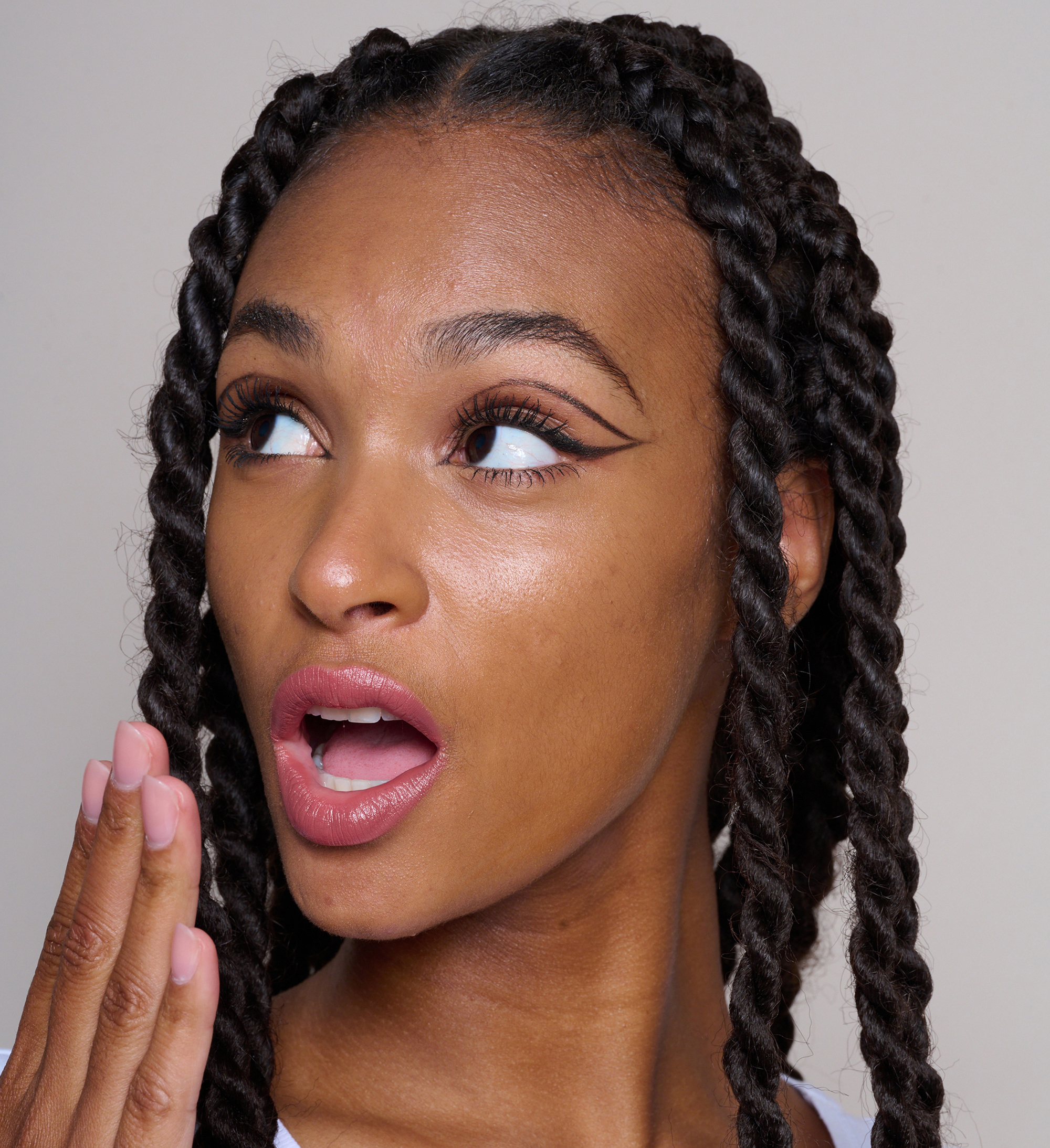 Model wearing Skin Loving BB Cream, Hydraboost Lip Lover Lipstick in Spiced, Intensifying Lash Lover mascara and Highliner in Black and Gold