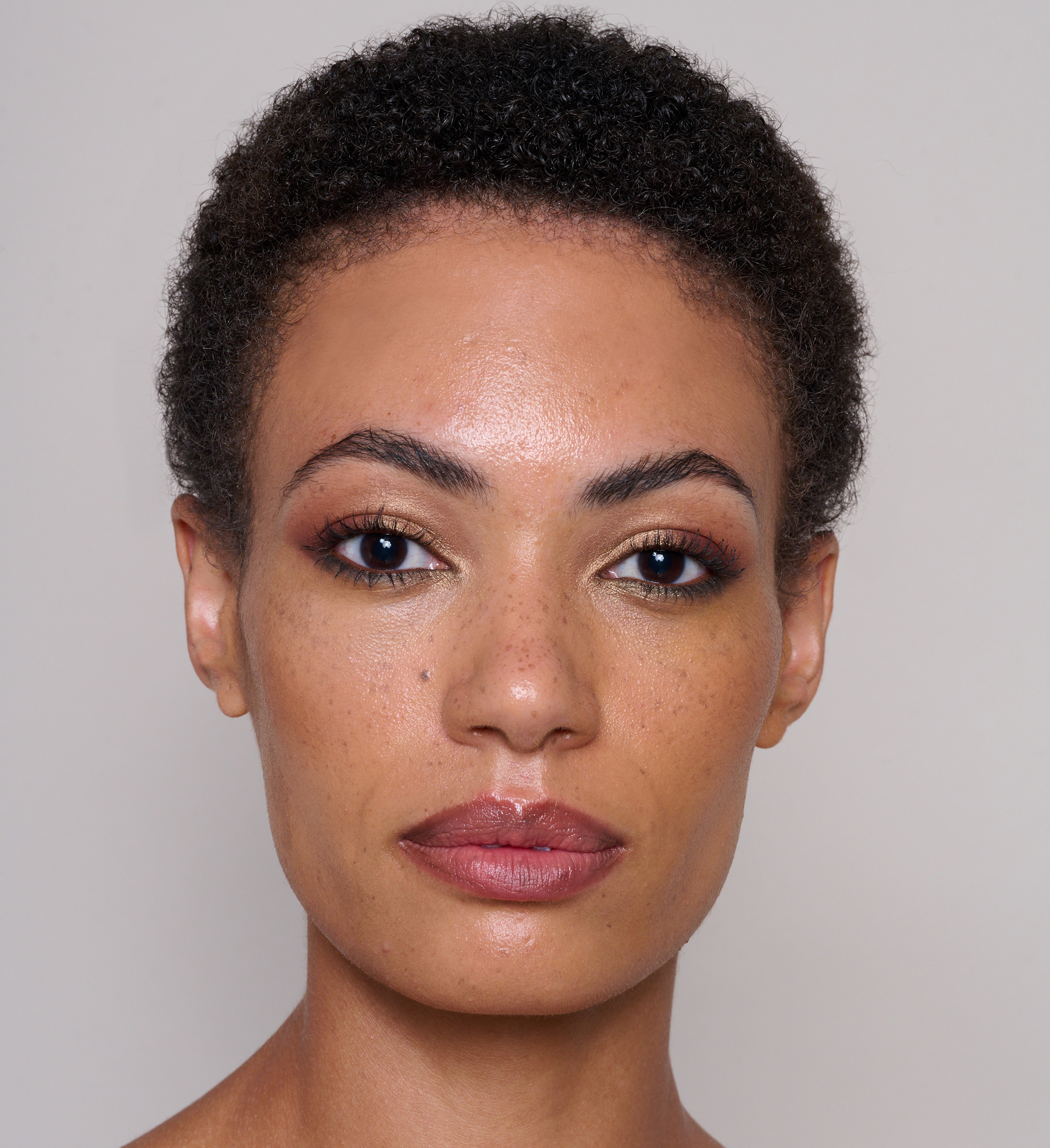 Model wearing Skin Secret Cream Tint, Finishing Brow Gel, Cosmos Earthly Beauty, Luscious Lip Sheen in Relish and Showstopping Lash Lover Mascara