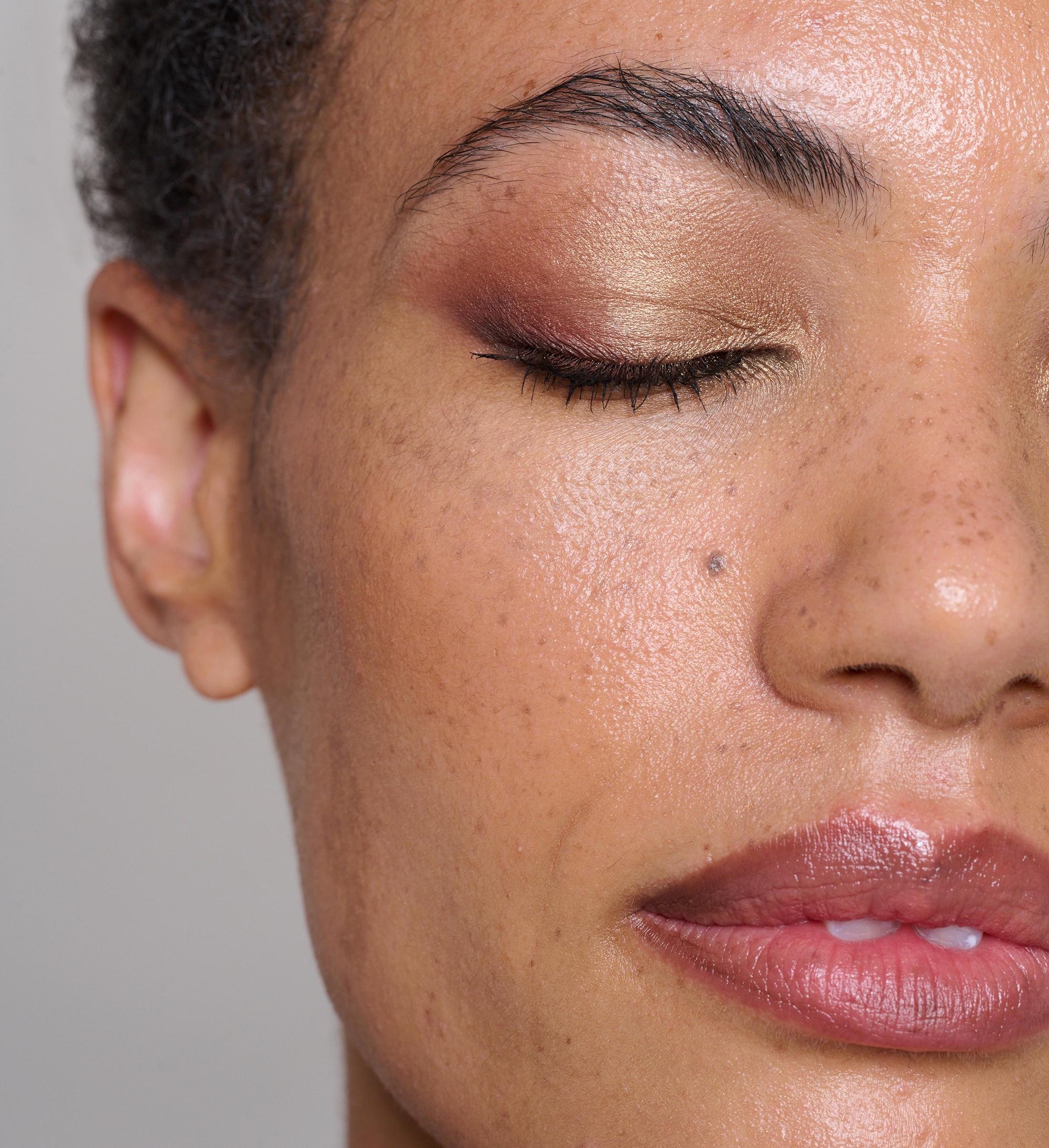 Model wearing Skin Secret Cream Tint, Finishing Brow Gel, Cosmos Earthly Beauty, Luscious Lip Sheen in Relish and Showstopping Lash Lover Mascara