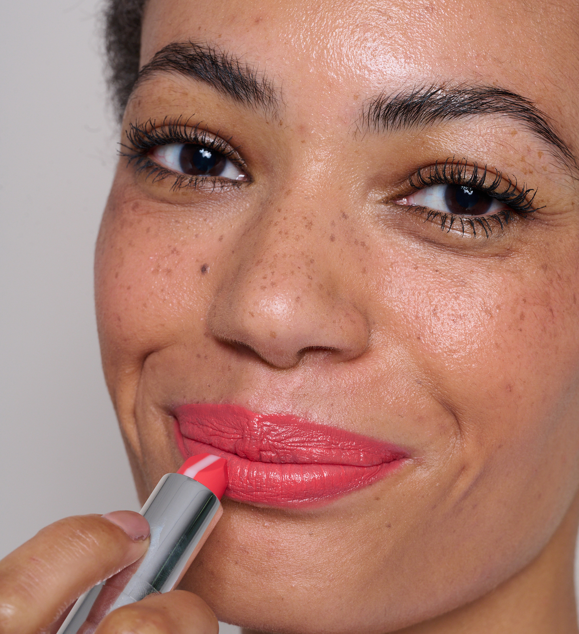 Model applying Hydraboost Lip Lover Lipstick Tutti Frutti