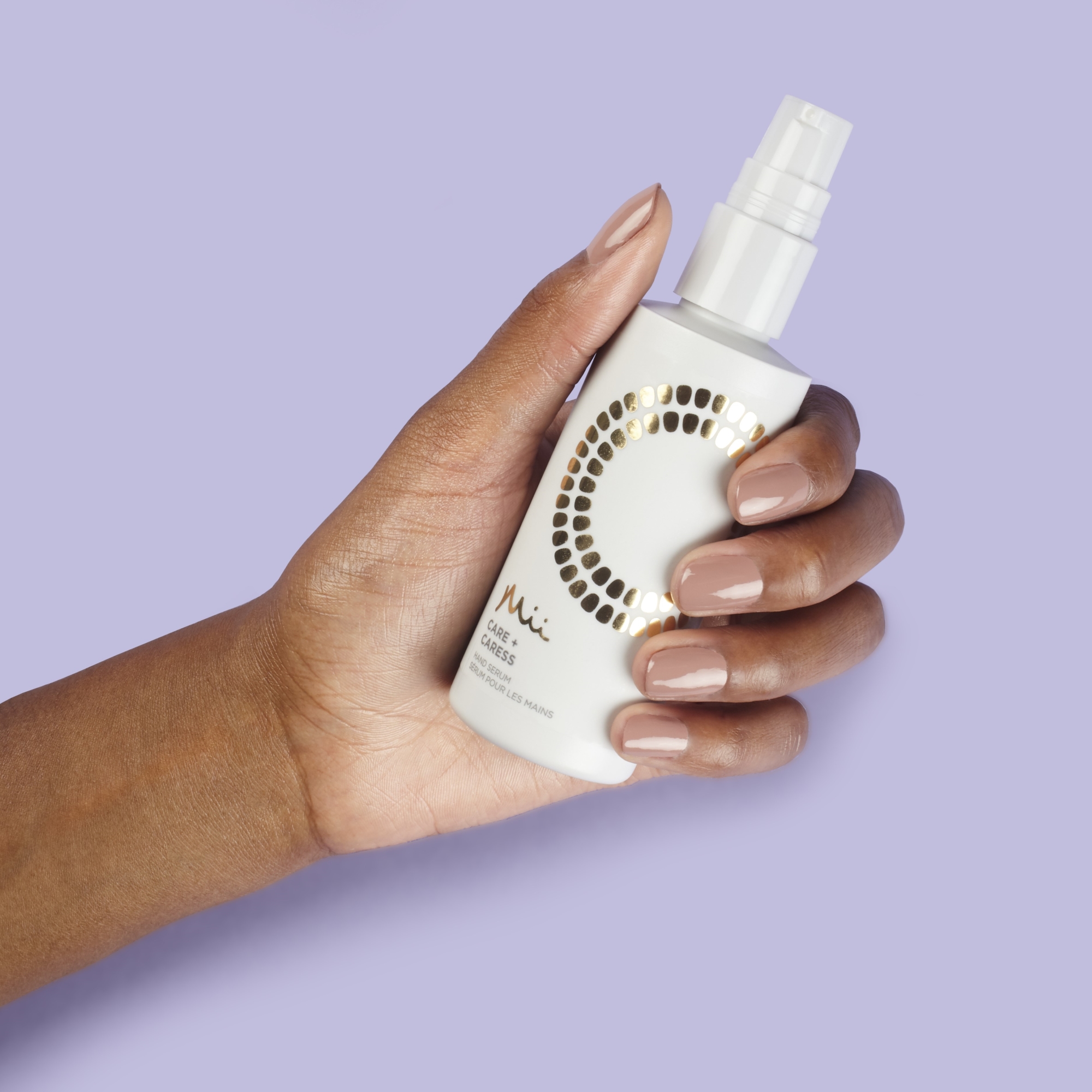 Model holding Care + Caress Hand Serum