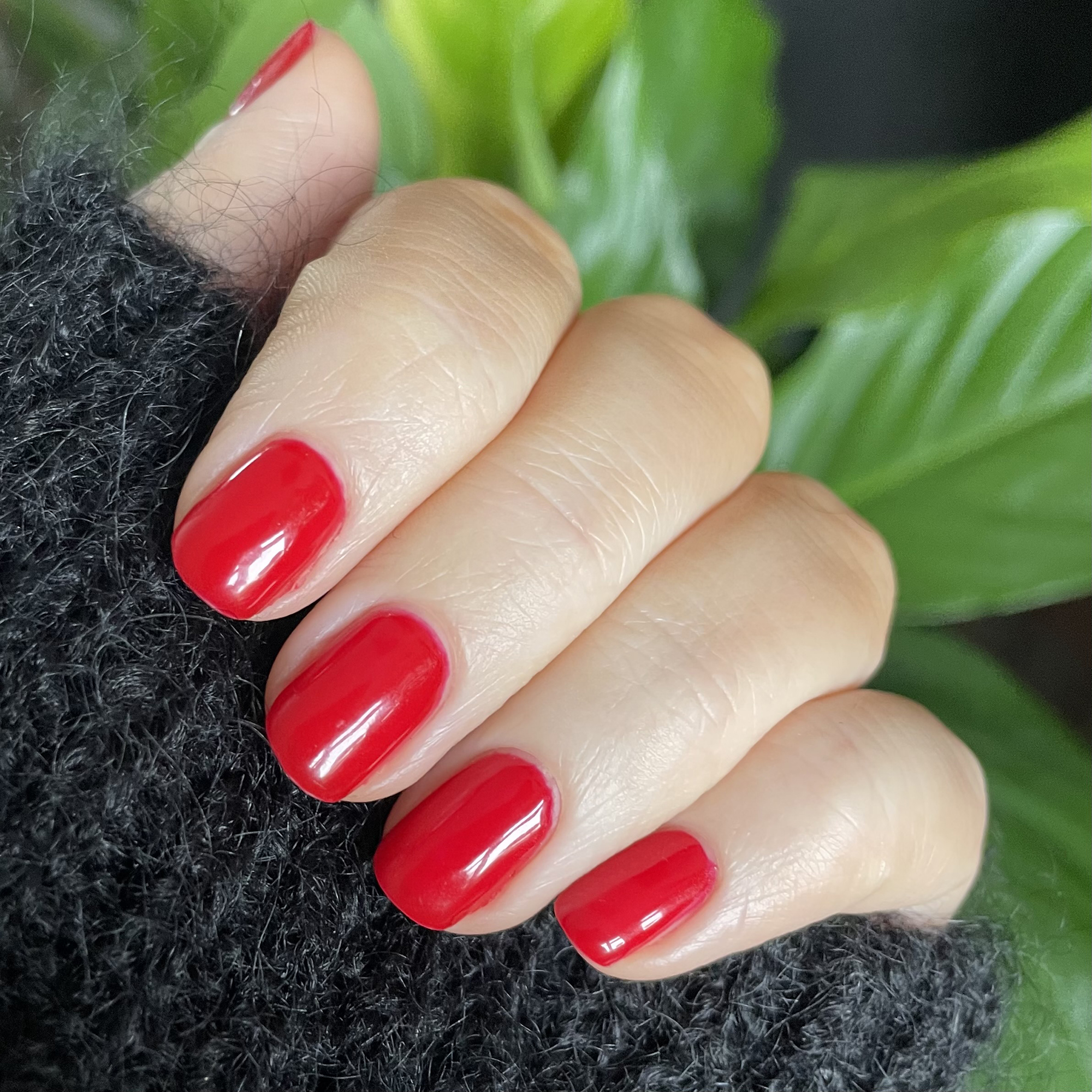 Model wearing Colour Confidence Nail Polish in Red Devil