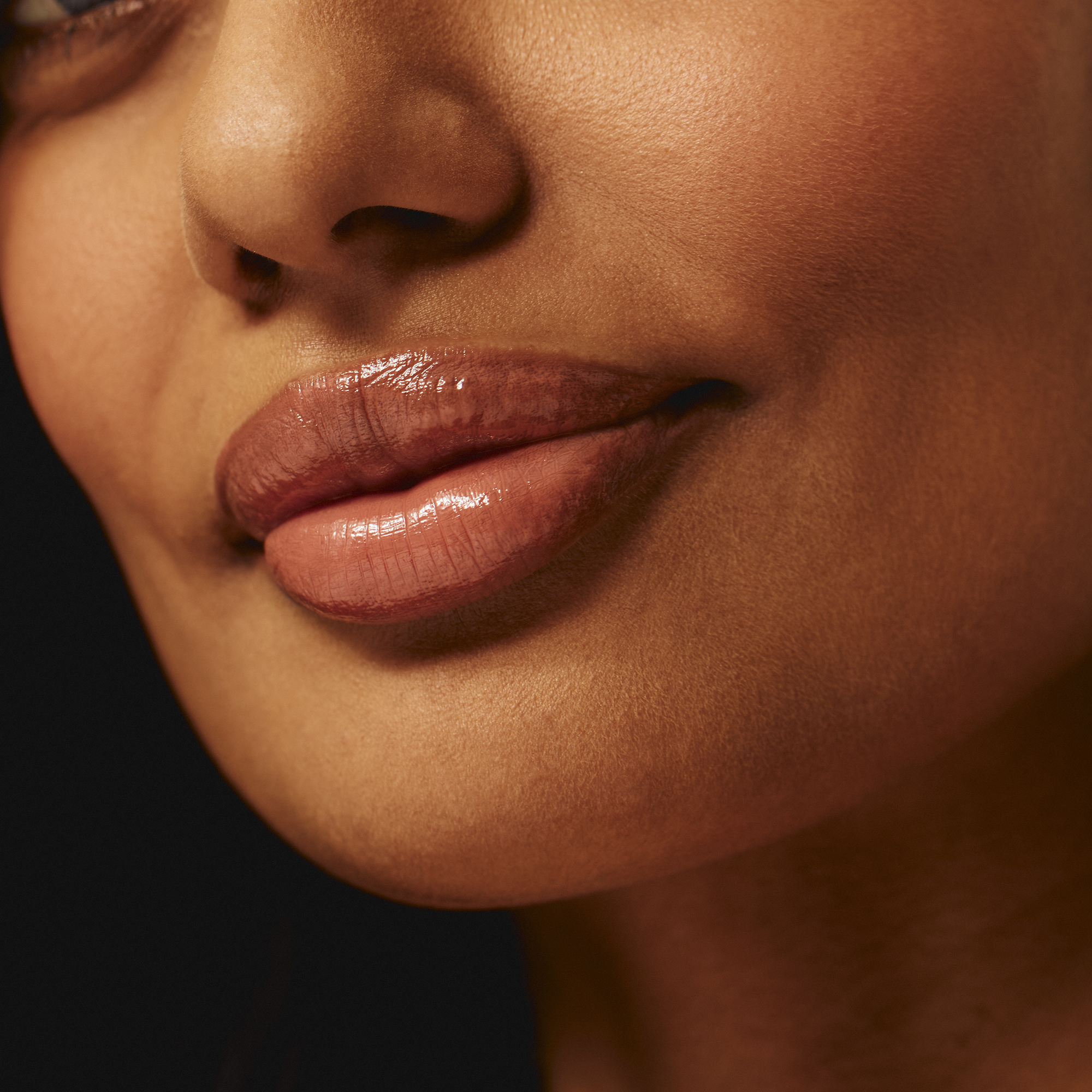 Model wearing Luscious Lip Sheen Lip Gloss in Indulge