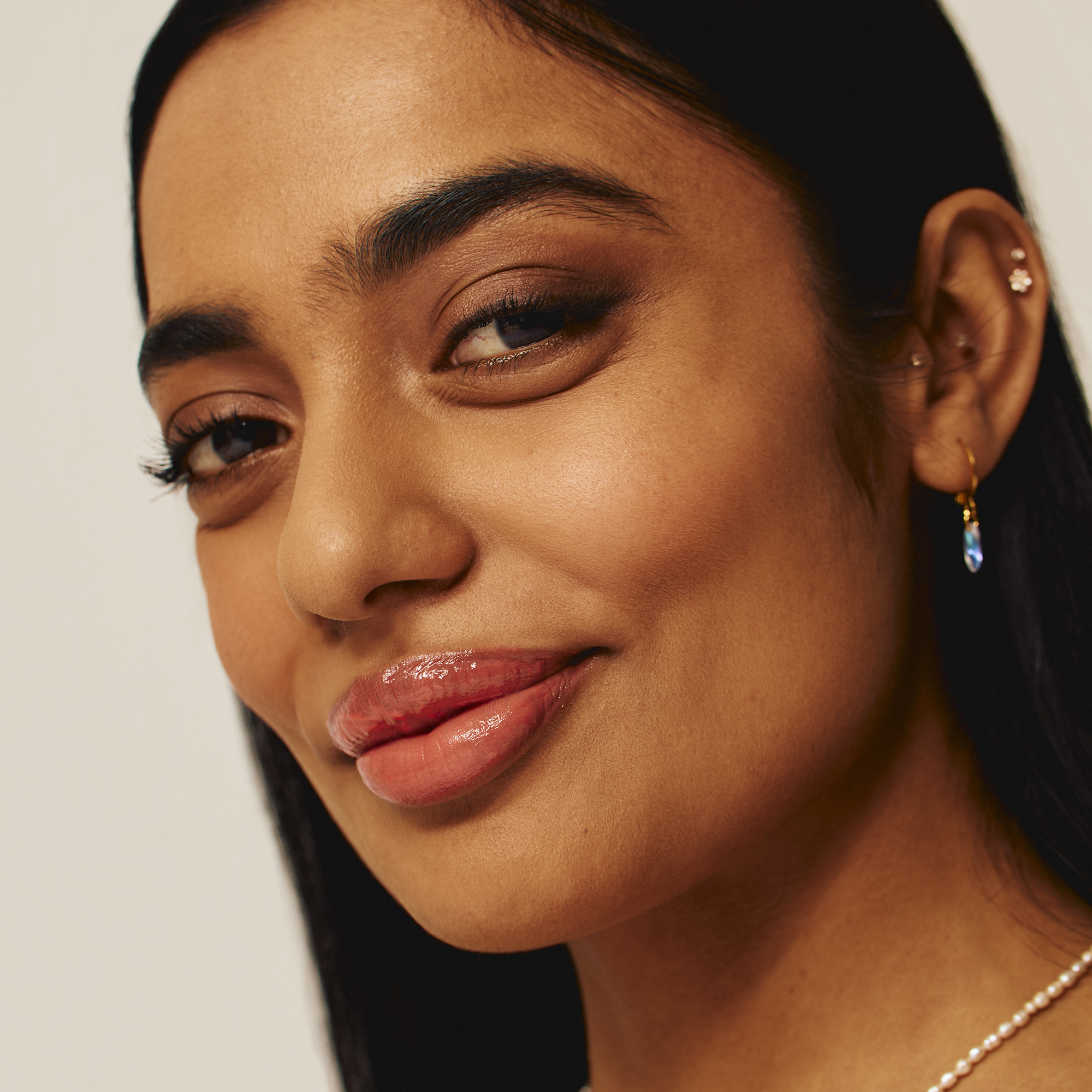 Model wearing Luscious Lip Sheen Lip Gloss in Delectable