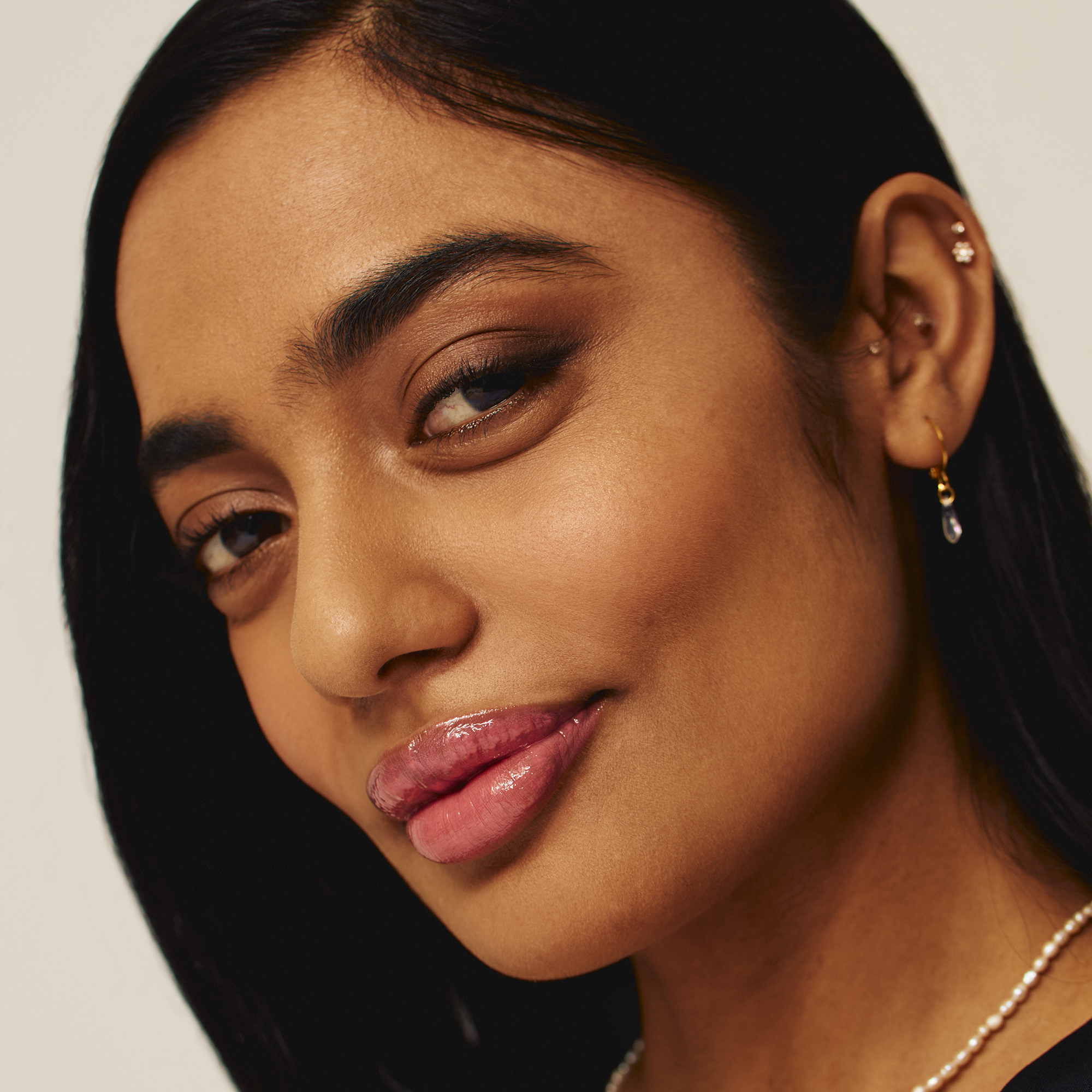 Model wearing Luscious Lip Sheen Lip Gloss in Sweet Pea