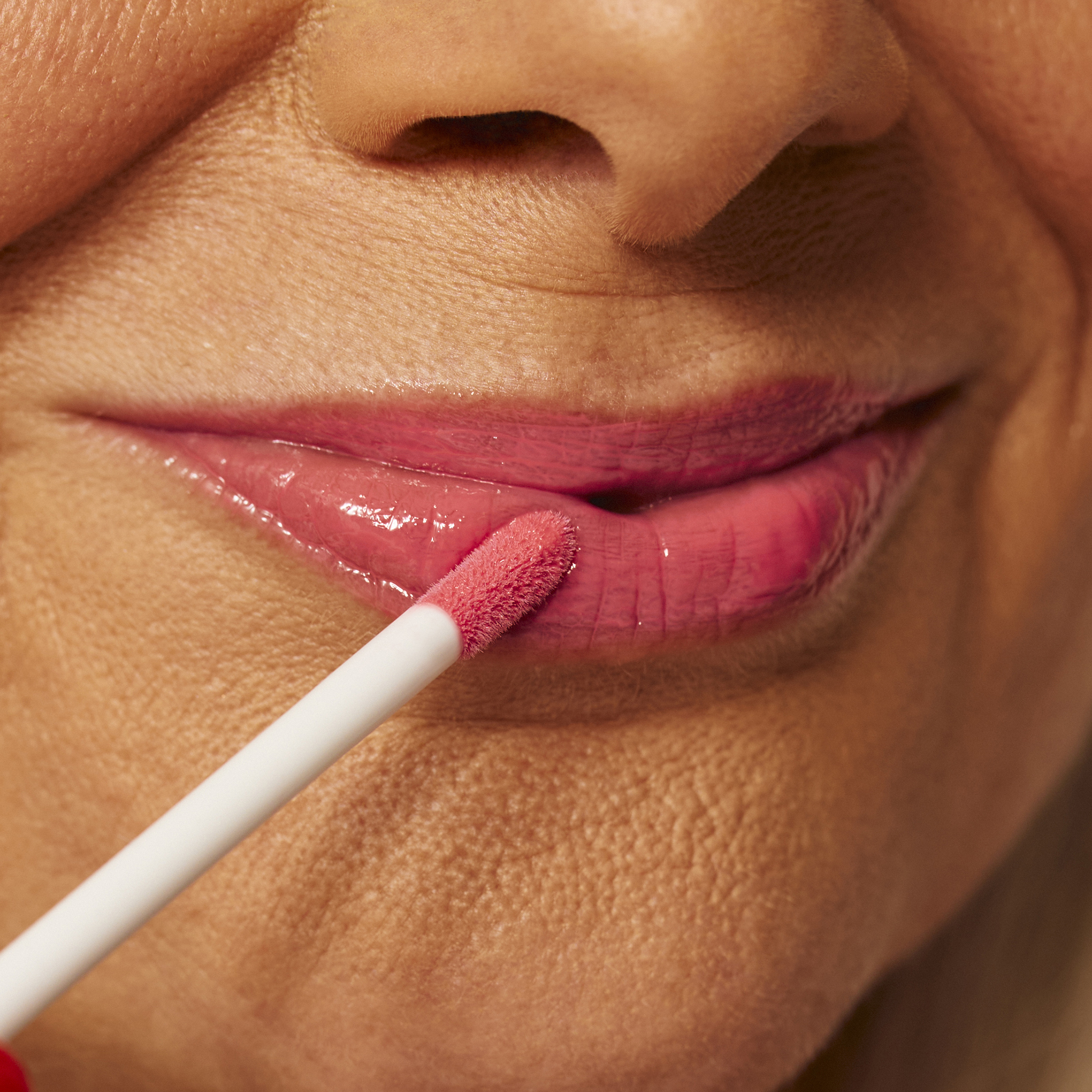 Model wearing Luscious Lip Sheen Lip Gloss in Sweet Pea