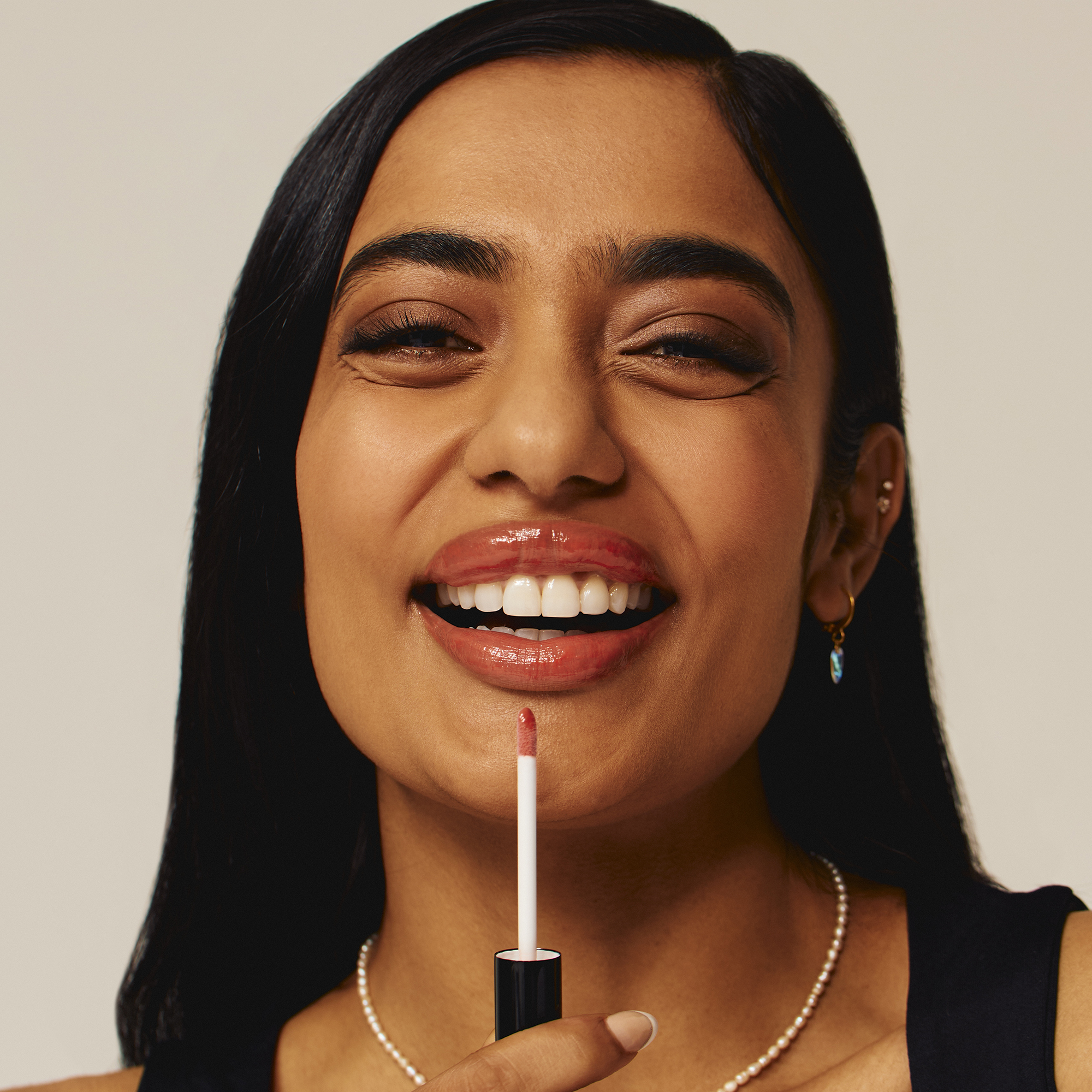 Model wearing Luscious Lip Sheen Lip Gloss in Charmed