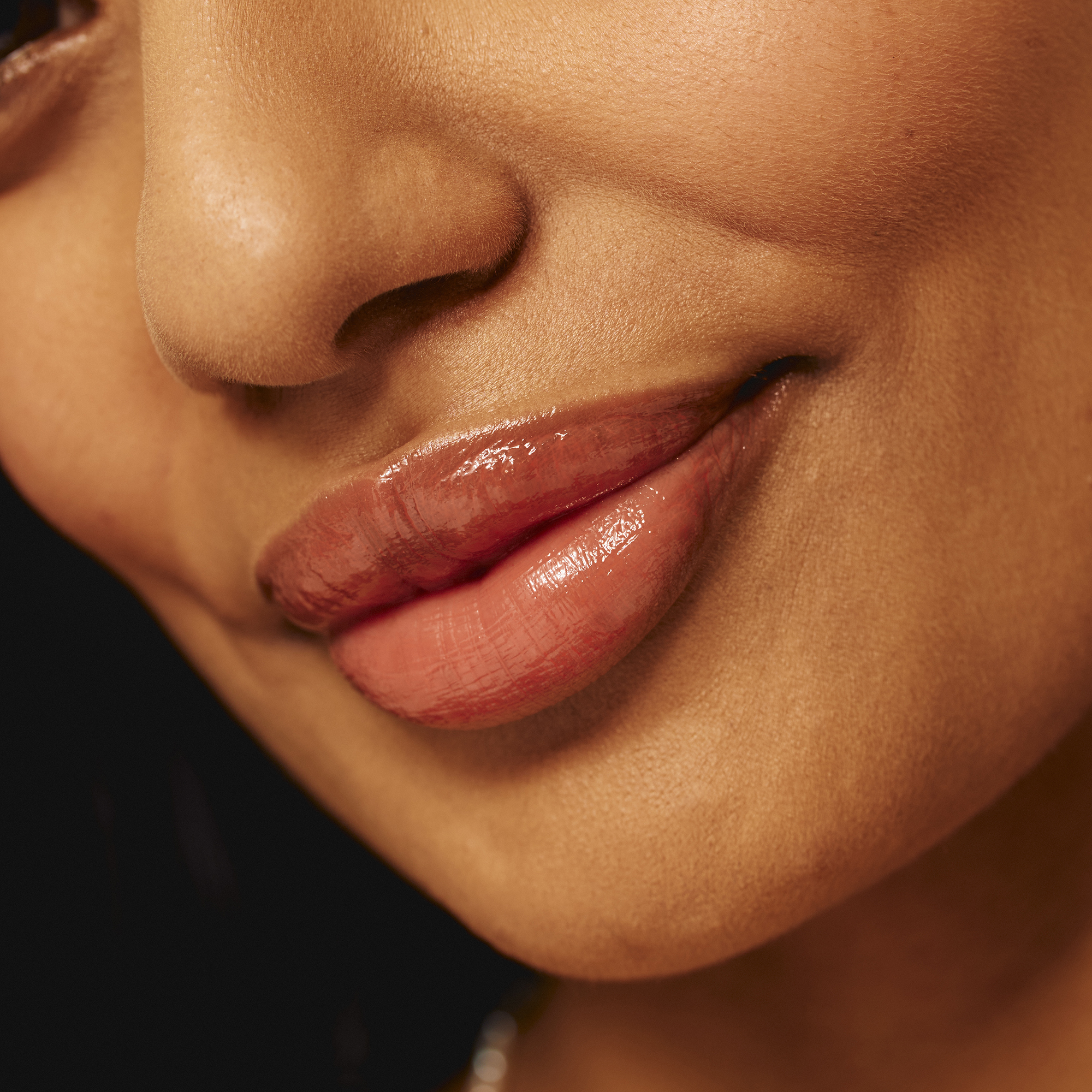 Model wearing Luscious Lip Sheen Lip Gloss in Charmed