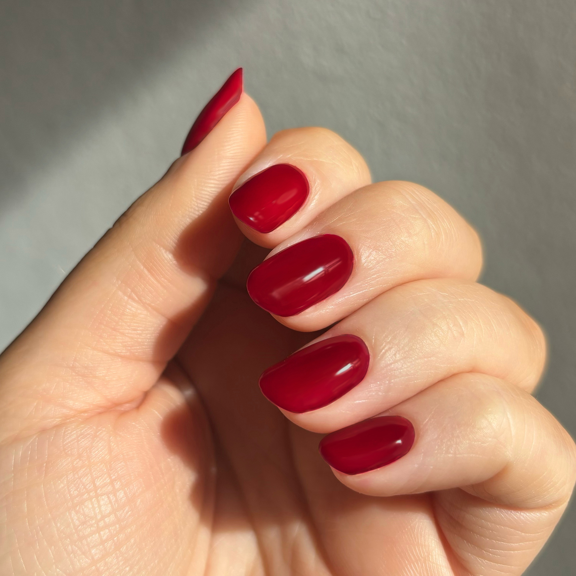 Model wearing Bloodline Cherry Colour Confidence Nail Polish