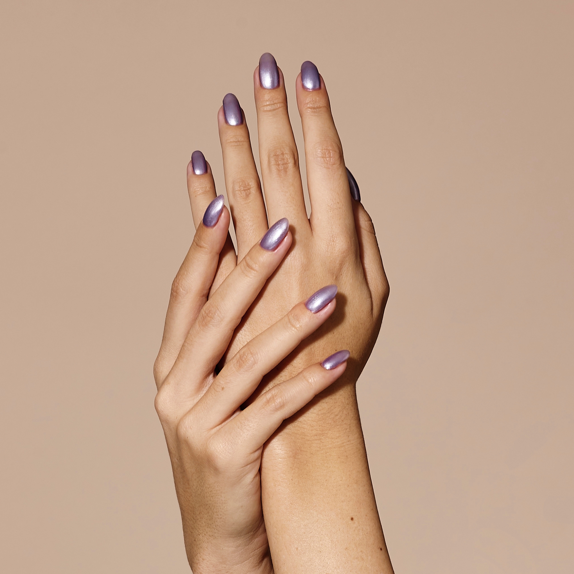 Model wearing metallic nail polish