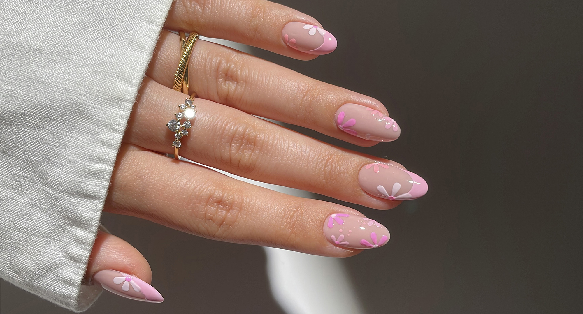 Model wearing a floral nail art design
