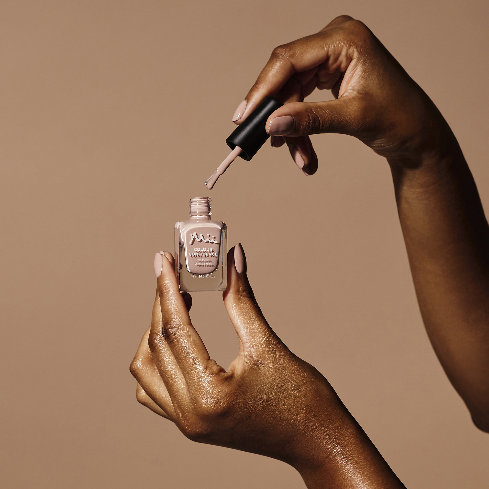 Model holding and wearing At One With Nature Colour Confidence Nail Polish