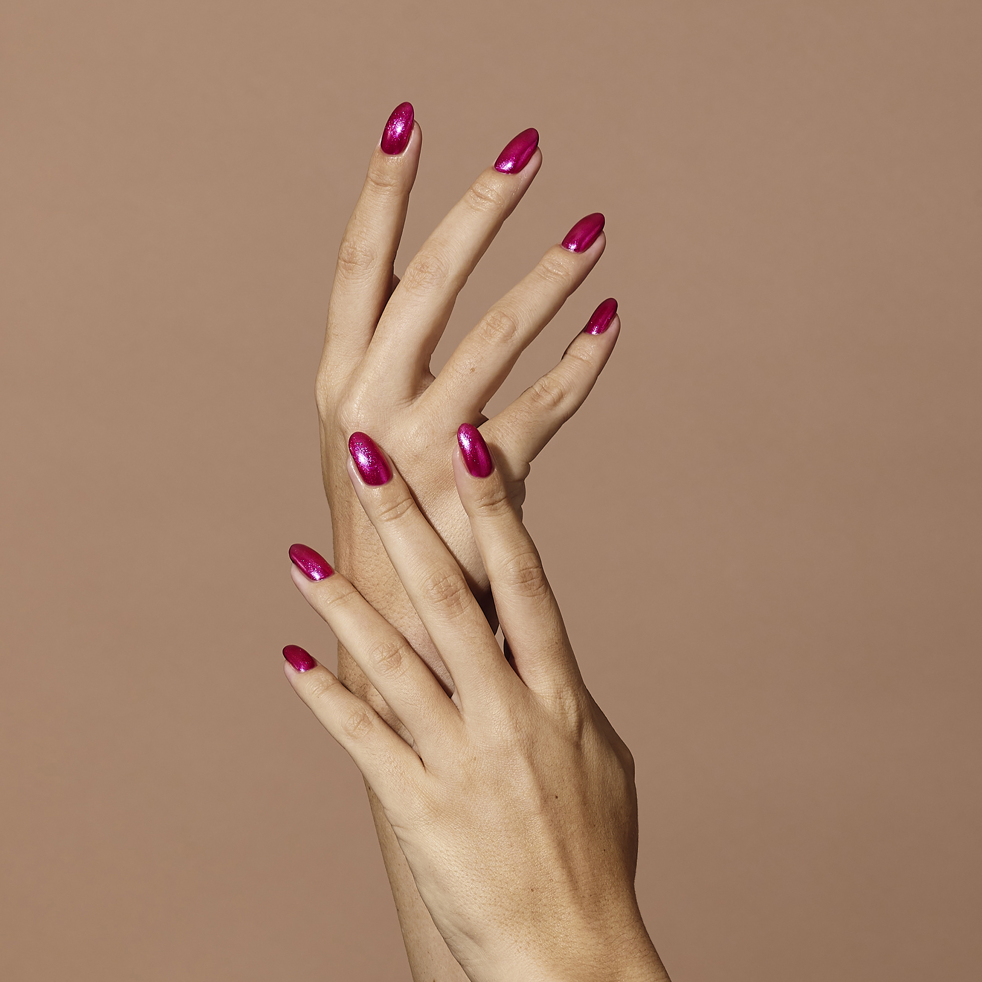 Models holding Raspberry Ripple Colour Confidence Nail Polish