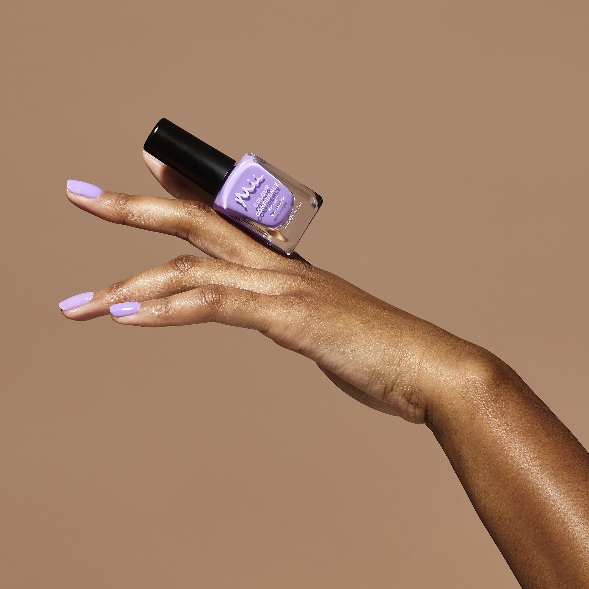 Model holding Masquerade Colour Confidence Nail Polish