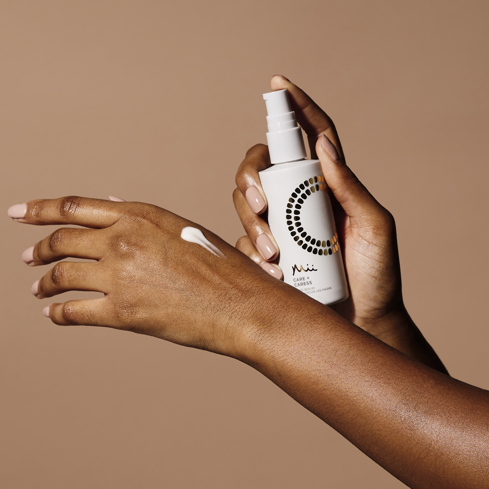 Model applying Care + Caress Hand Serum
