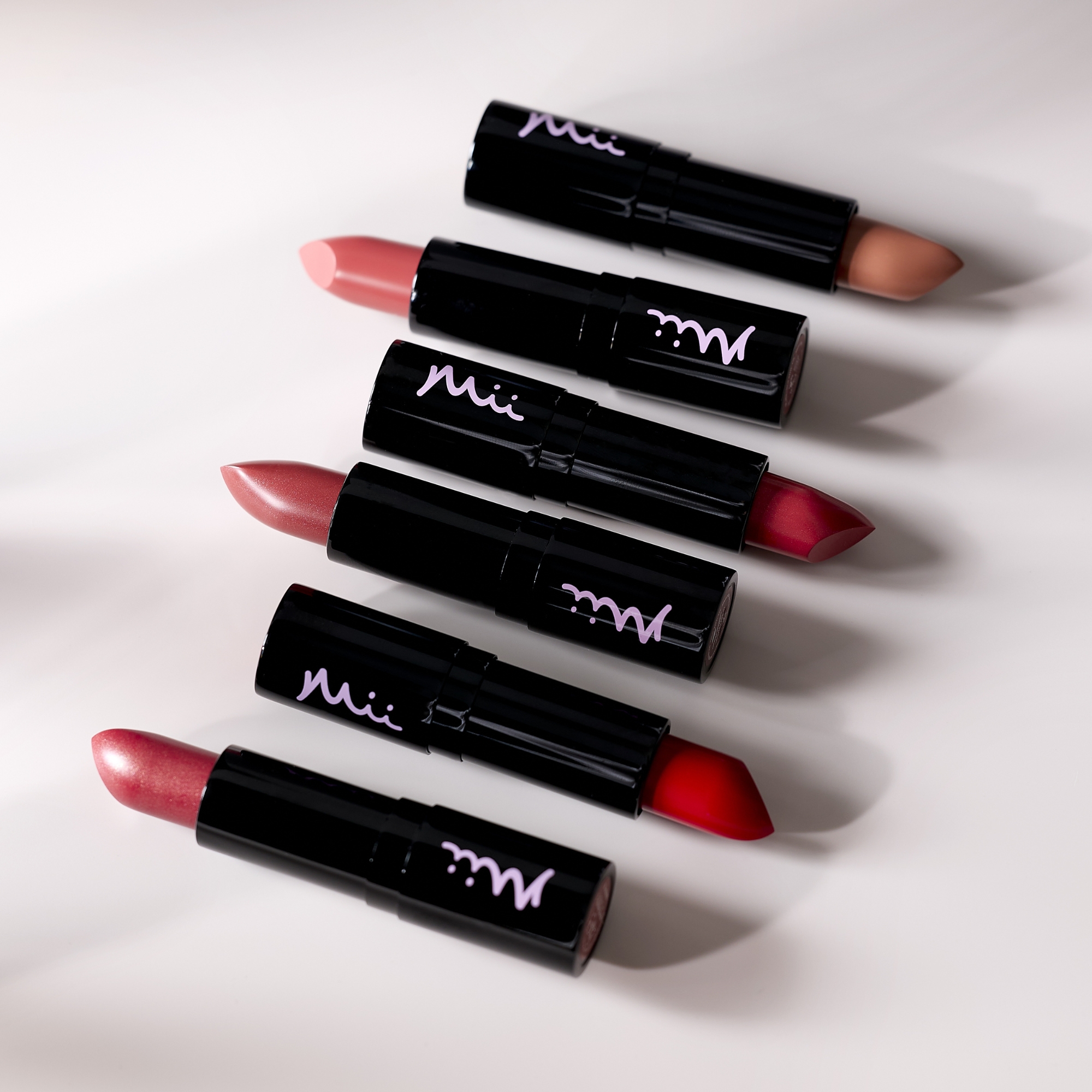Moisturising Lip Lover Lipstick in assorted shades on a grey background