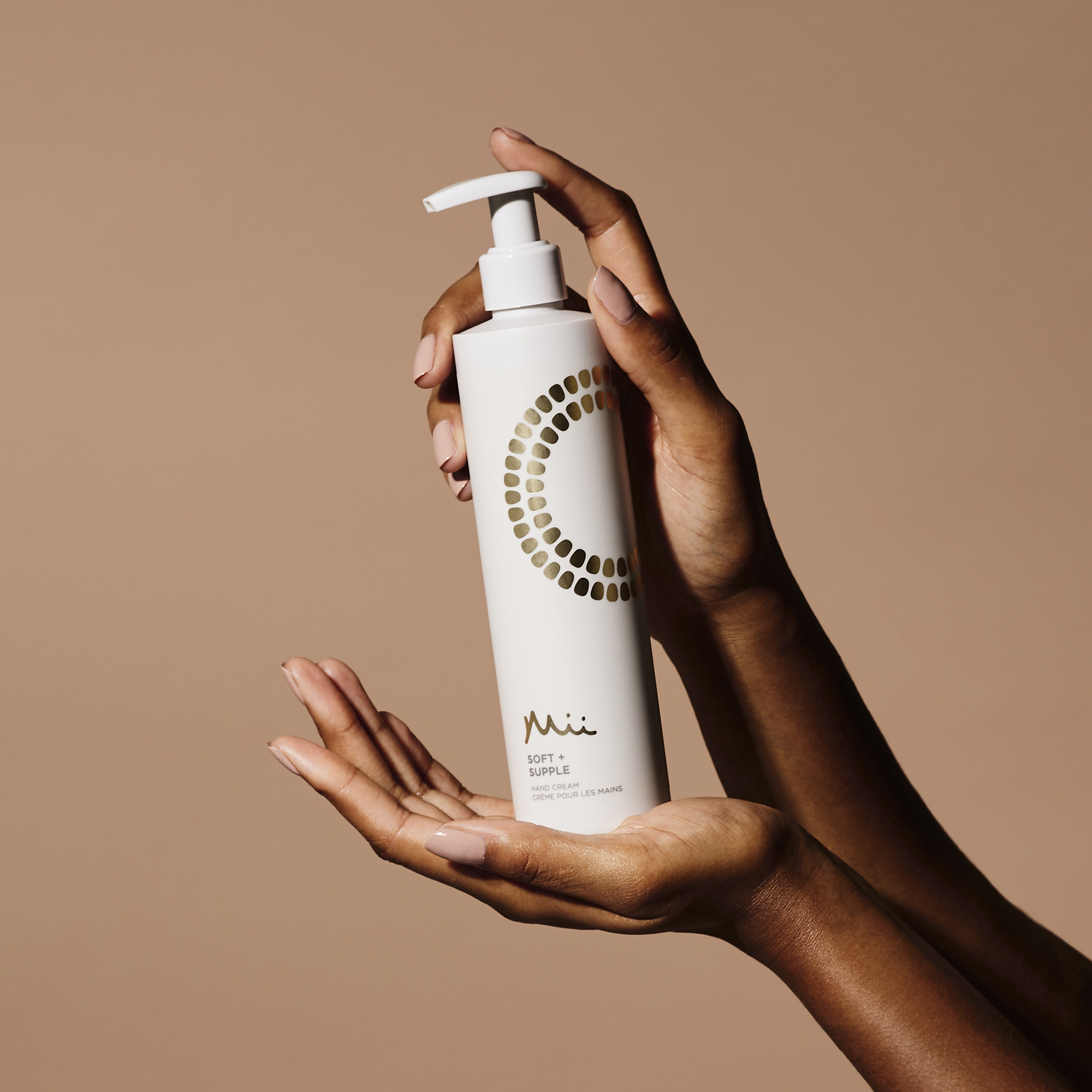 Model holding Soft + Supple Hand Cream