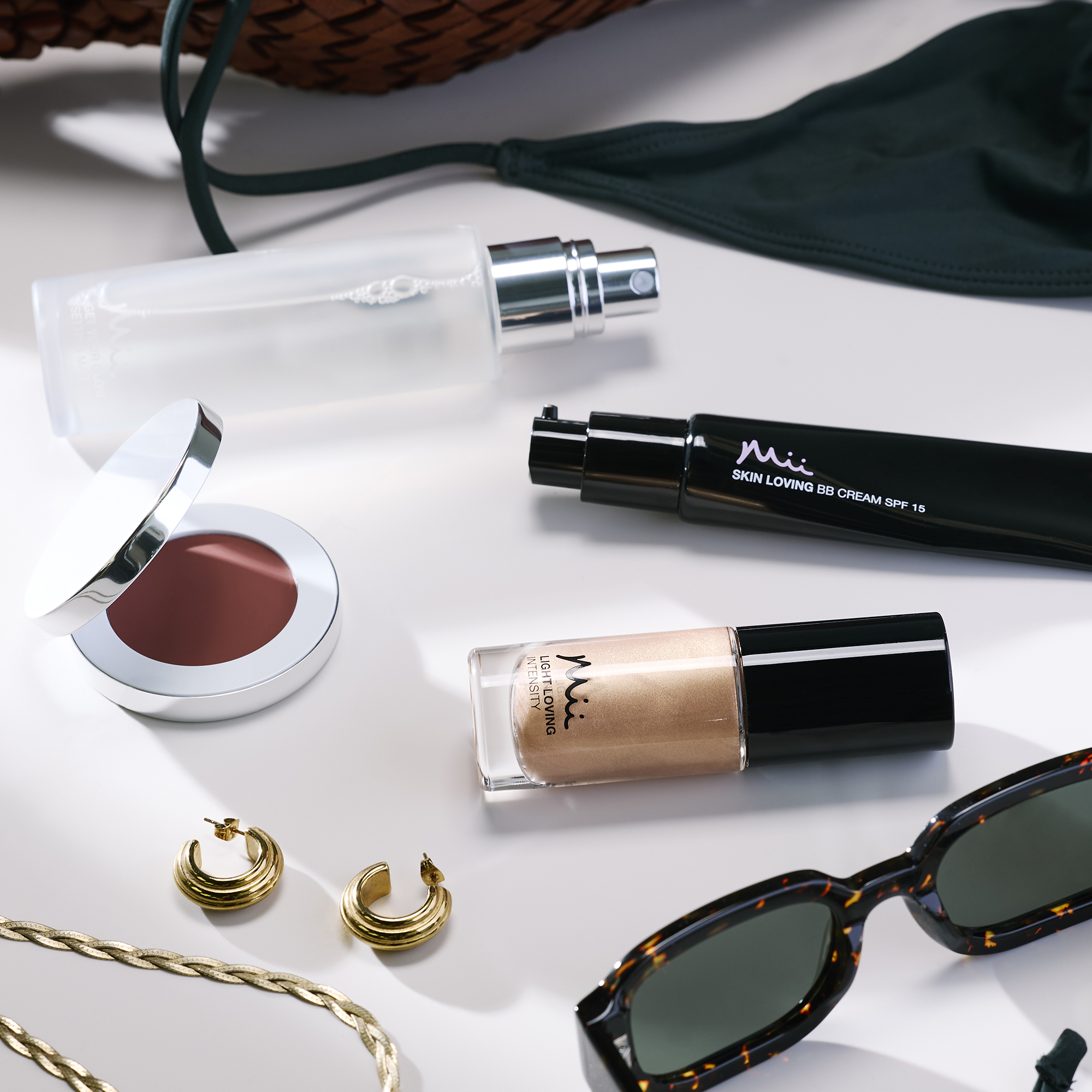 Group stylised shot of Light Loving Intensity Liquid Highlighter, Colour Wonder Lip and Cheek Balm, Skin Loving BB Cream and Get Your Glow Setting Mist