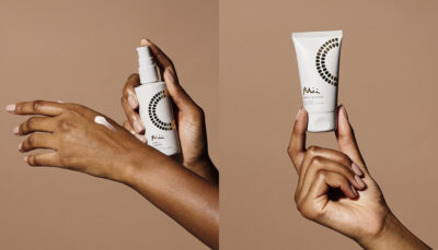 Image of model applying Care + Caress Hand Serum and holding Soft + Supple Hand Cream