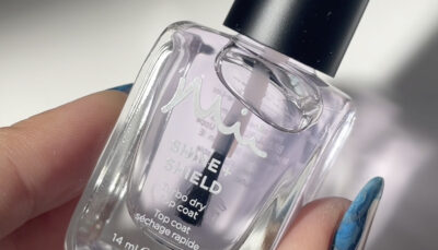 Hands holding a bottle of Shine + Shield Top Coat