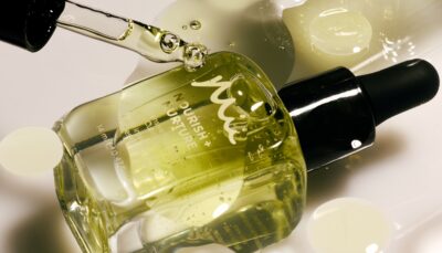 Nourish + Nurture Intense Cuticle Oil with glass applicator dispensing product