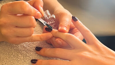 London Fashion Week - nail tech applying Gloss + Go top coat onto models nails