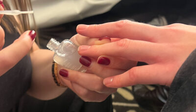 London Fashion Week - nail tech applying To Have + To Hold base coat onto models nails
