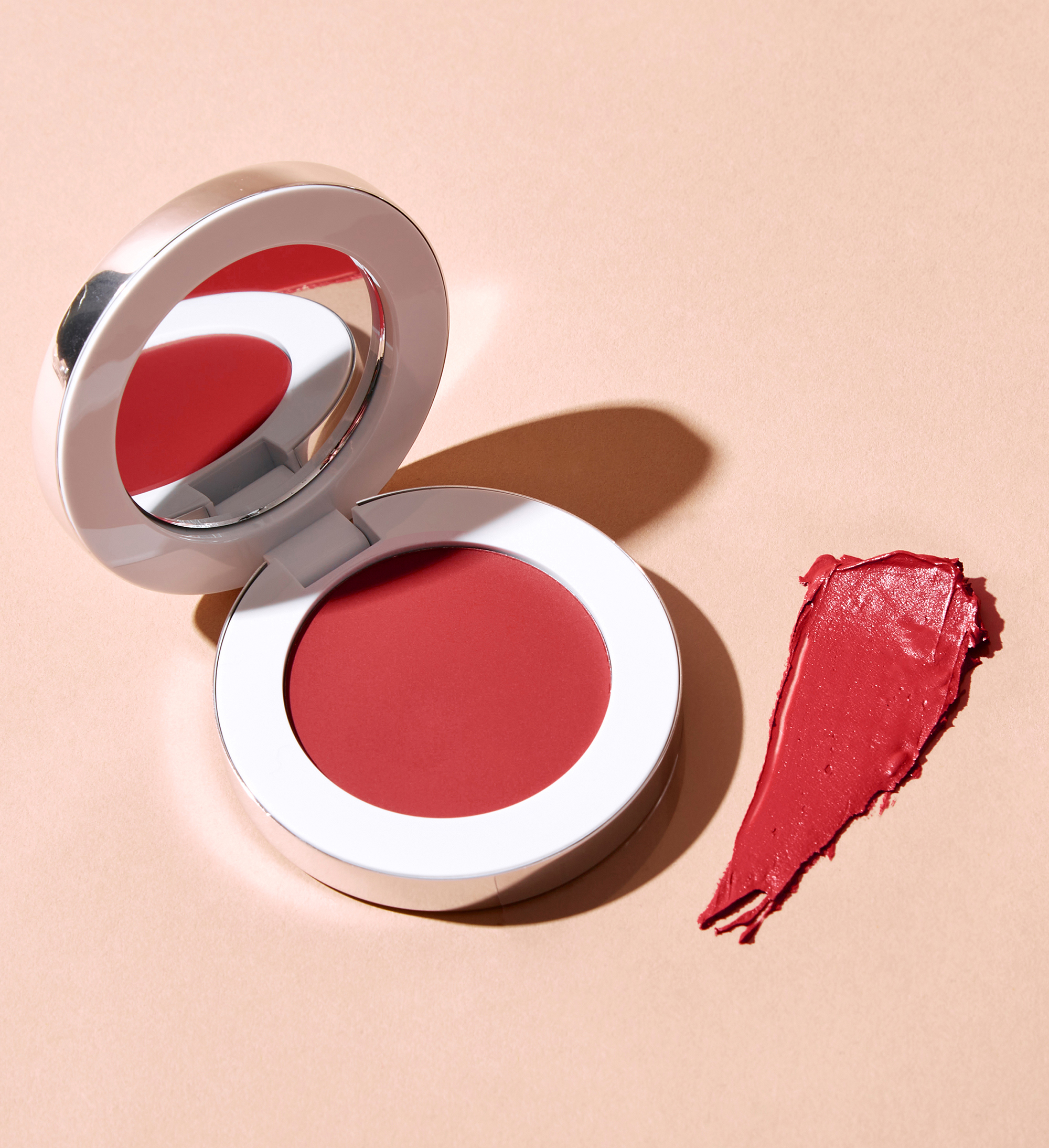 Colour Wonder Lip and Cheek Balm in Rebel Red opened against a neutral background