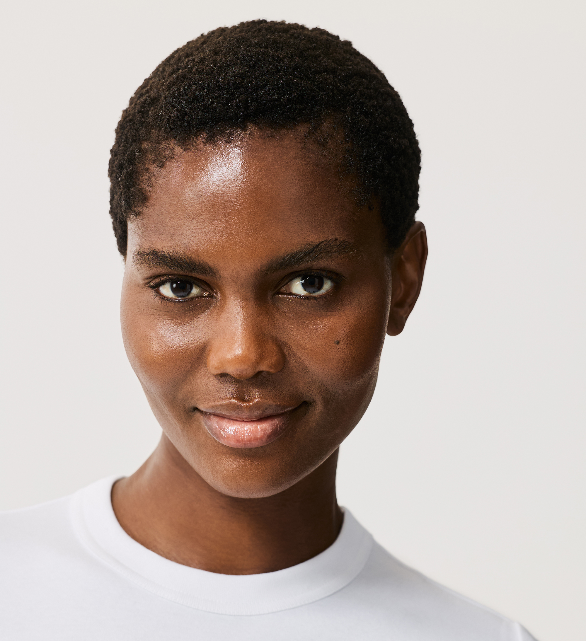 Model wearing Skin Perfecting Concealer in shade 18 against a neutral background