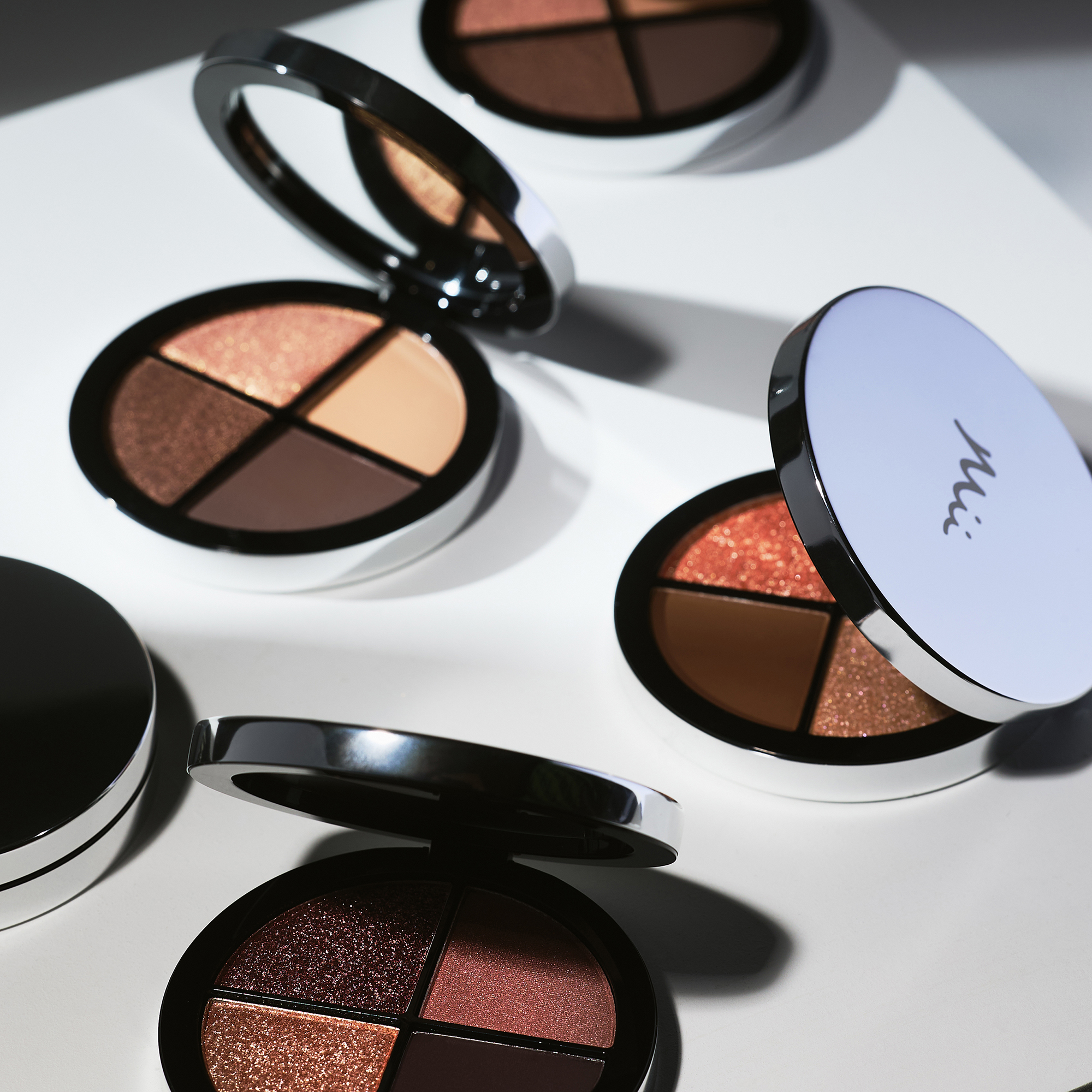 Shade Play Eyeshadow Pallete in Desert Moon, Copper Quartz, Midstone Mist and Midnight Bloom opened in a white surface