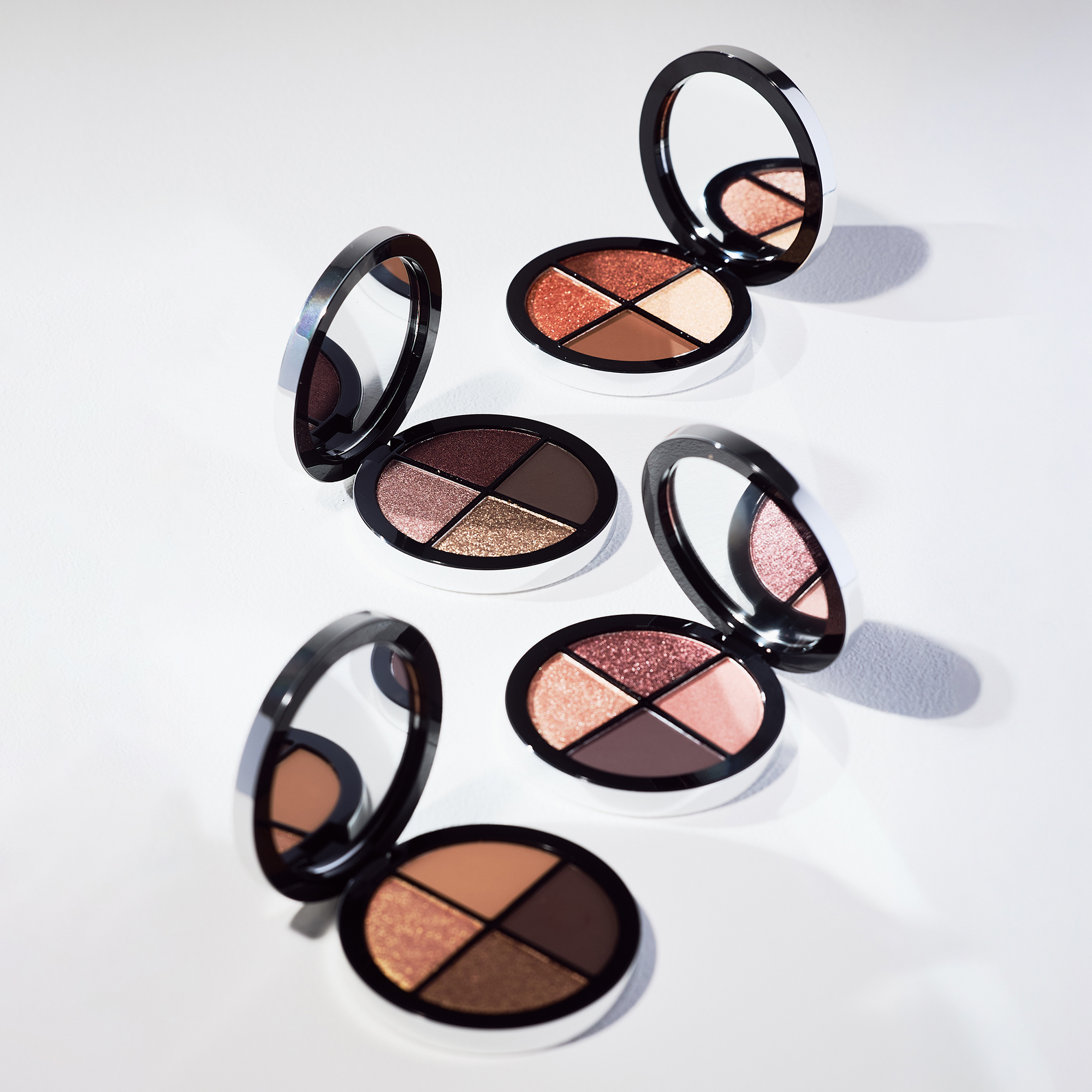 Shade Play Eyeshadow Pallete in Desert Moon, Copper Quartz, Midstone Mist and Midnight Bloom opened in a white surface