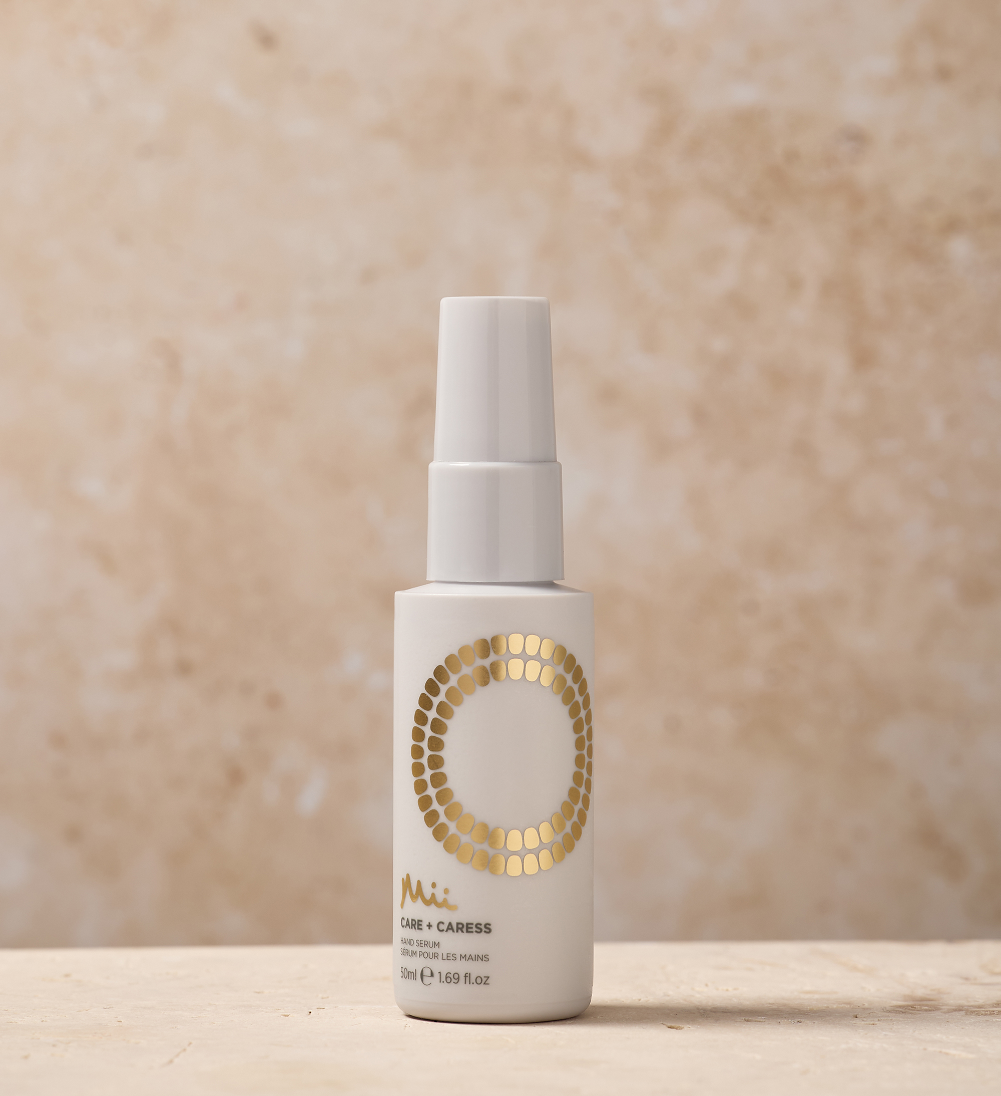 Care + Caress Hand Serum 50ml against a marble background